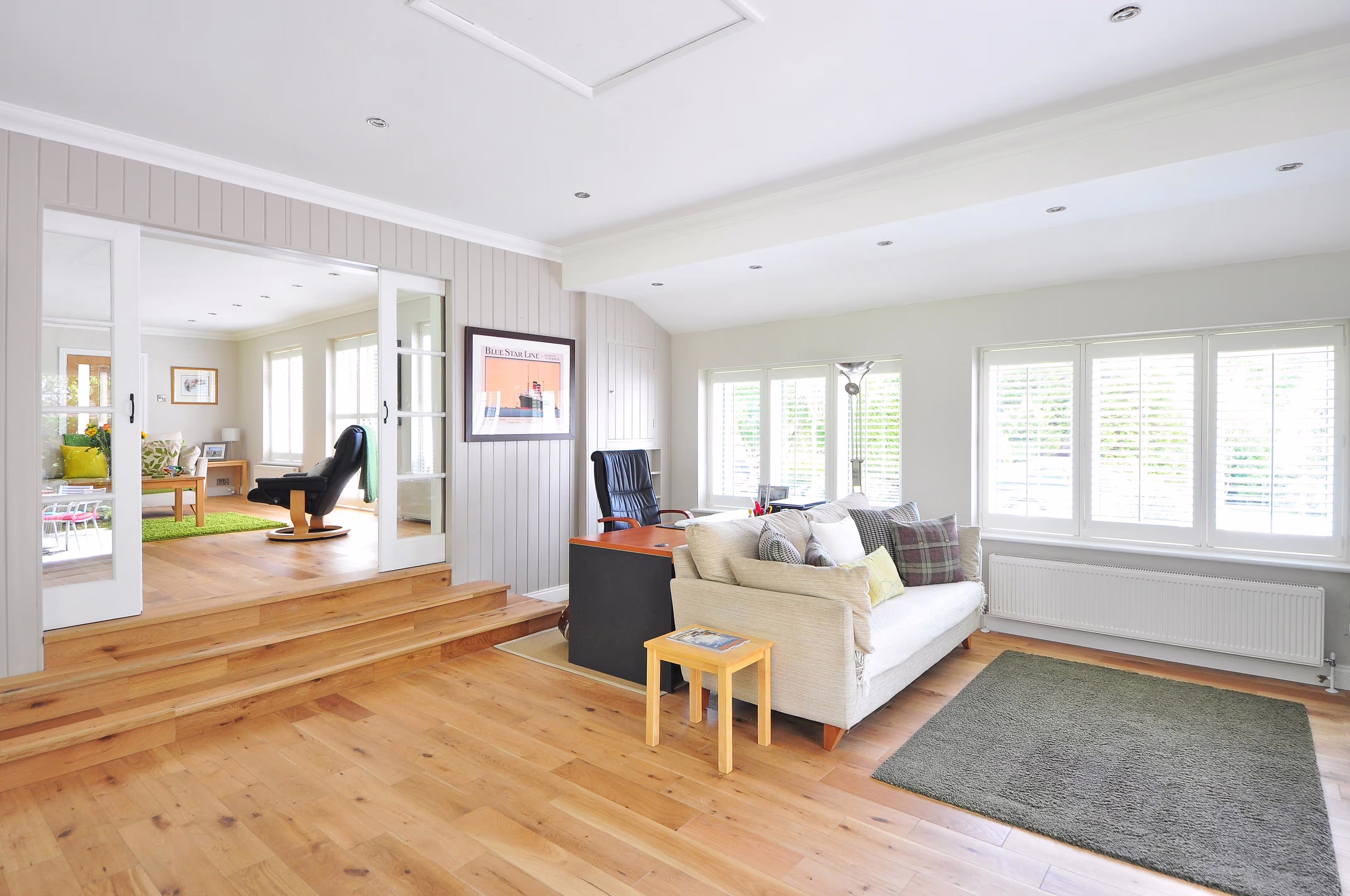 Bright living space with wooden floor and cozy seating